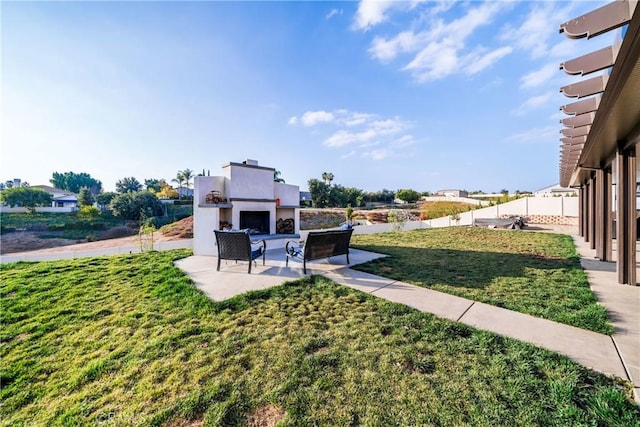 view of yard with a patio and an outdoor fireplace