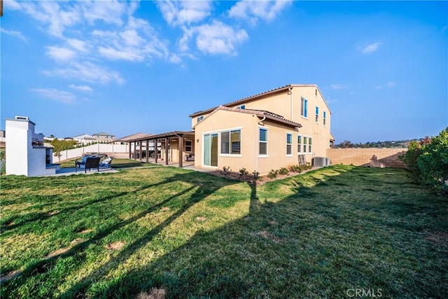 back of house with a lawn, cooling unit, and a patio area