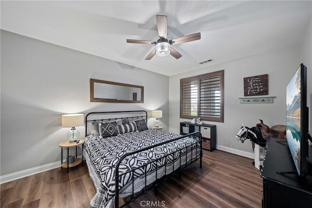 bedroom with ceiling fan and dark hardwood / wood-style flooring