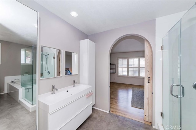 bathroom featuring hardwood / wood-style flooring, vanity, and an enclosed shower