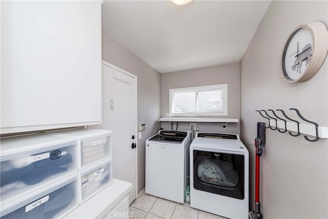 laundry room featuring light tile patterned floors and independent washer and dryer