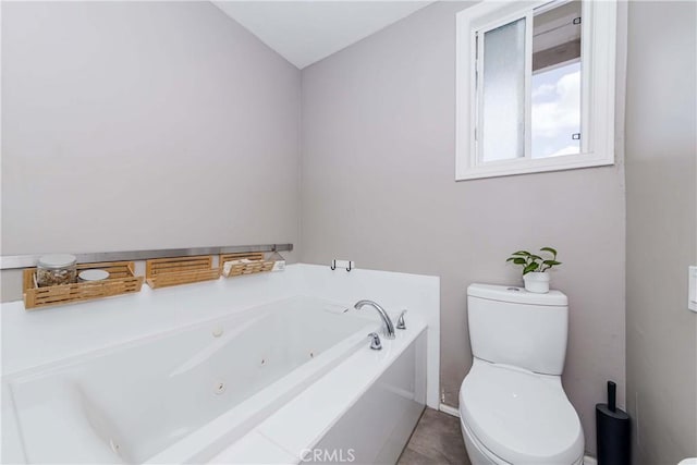 bathroom with a tub and toilet