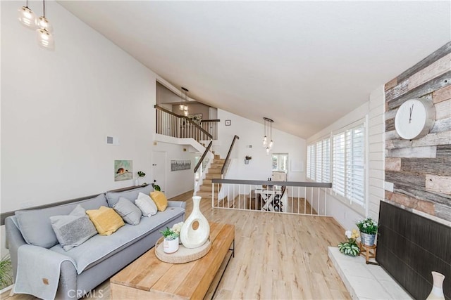 living room featuring vaulted ceiling and light wood-type flooring