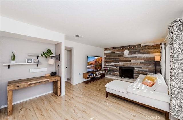 living room featuring light hardwood / wood-style floors and wood walls