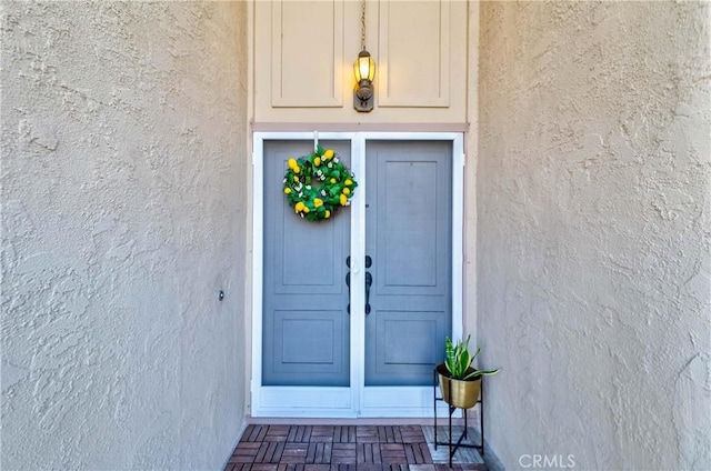 doorway to property with stucco siding