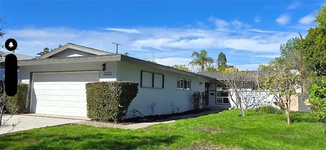 single story home featuring a garage and a front lawn