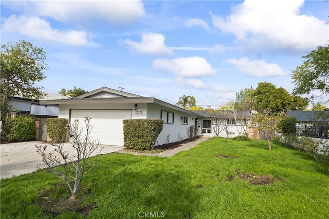 exterior space with a garage and a lawn