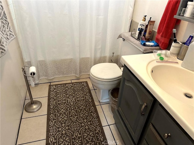 full bathroom featuring shower / tub combo with curtain, tile patterned floors, toilet, and vanity