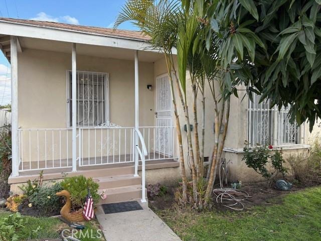 property entrance featuring covered porch