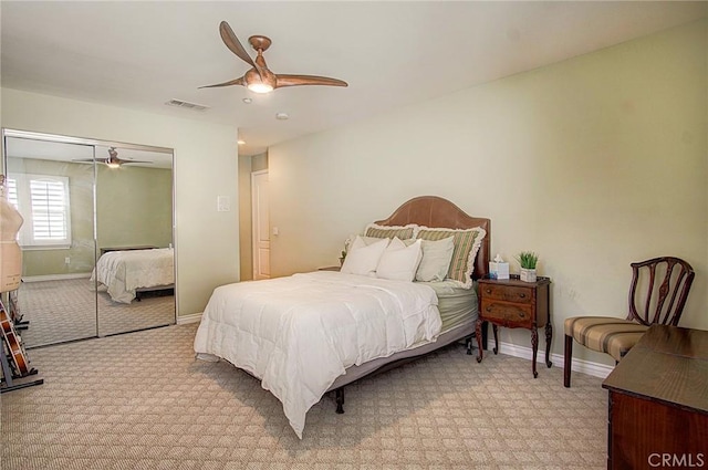 bedroom featuring ceiling fan, a closet, and light carpet