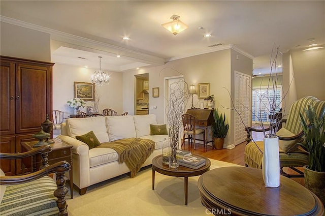 living area featuring ornamental molding, a chandelier, and light hardwood / wood-style flooring