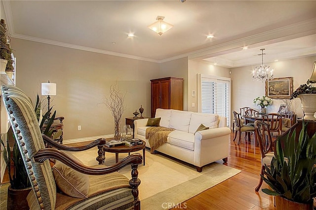 living room featuring an inviting chandelier, ornamental molding, and light wood-type flooring