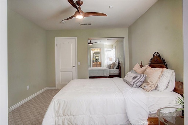 carpeted bedroom with ceiling fan and a closet