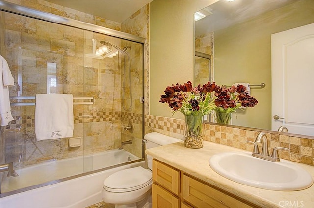 full bathroom with vanity, combined bath / shower with glass door, and toilet