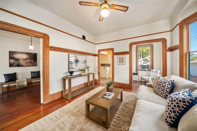 living room with dark wood-type flooring and ceiling fan