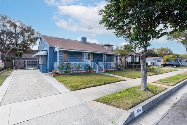 bungalow featuring a porch and a front lawn