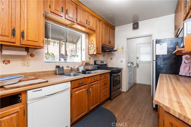 kitchen featuring sink, butcher block counters, white dishwasher, stainless steel gas range oven, and dark hardwood / wood-style flooring