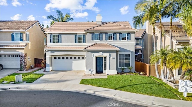 view of front of home featuring a garage and a front yard