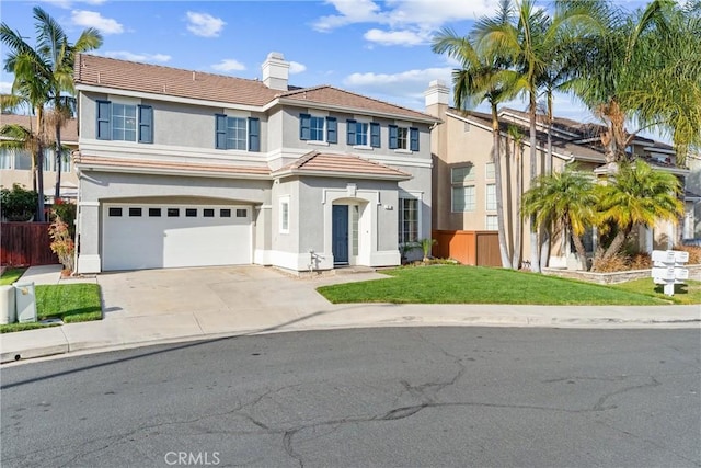 view of front of home with a front yard and a garage