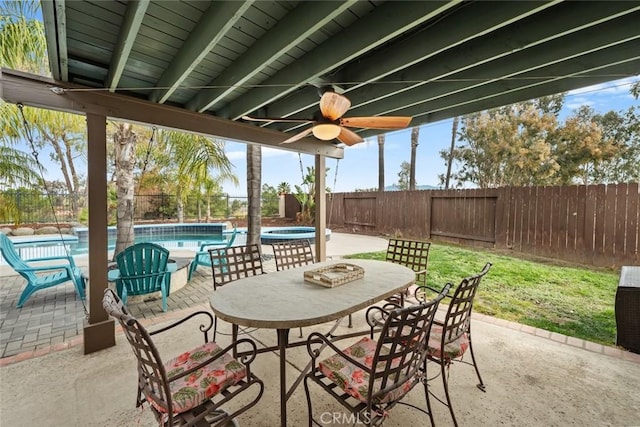 view of patio / terrace featuring ceiling fan and a pool with hot tub