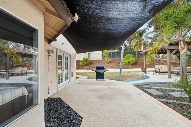 view of patio / terrace with a grill and french doors