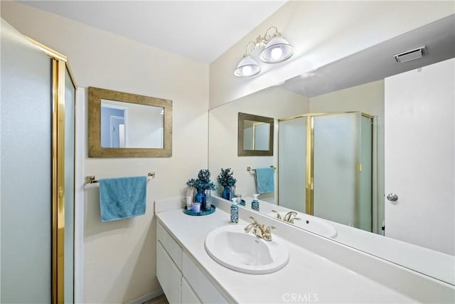 bathroom featuring vanity and a shower with shower door