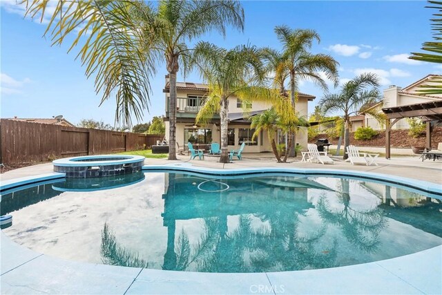 view of pool featuring an in ground hot tub and a patio area