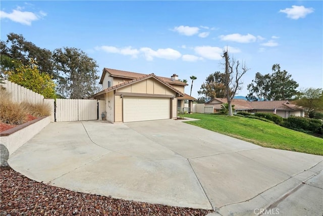 view of front of home with a garage and a front lawn