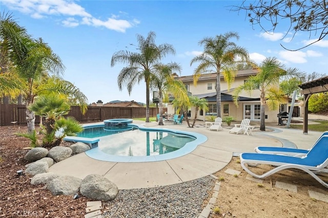 view of pool with french doors, an in ground hot tub, and a patio