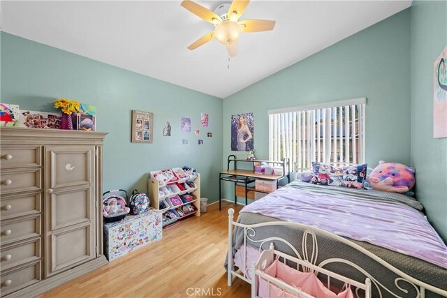 bedroom featuring ceiling fan, lofted ceiling, and light hardwood / wood-style floors