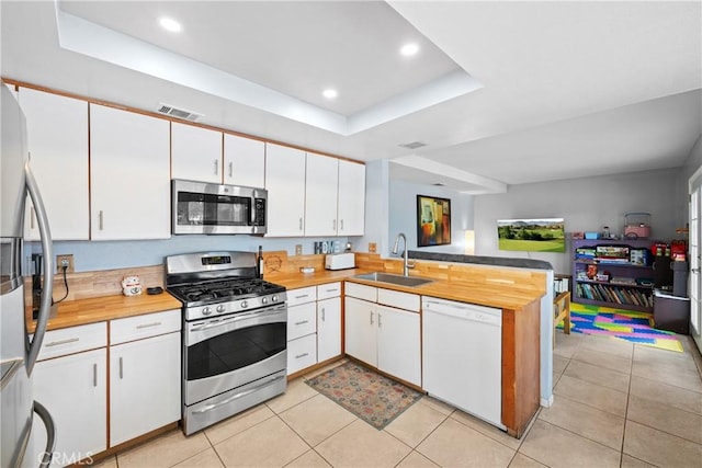 kitchen with white cabinetry, sink, and stainless steel appliances