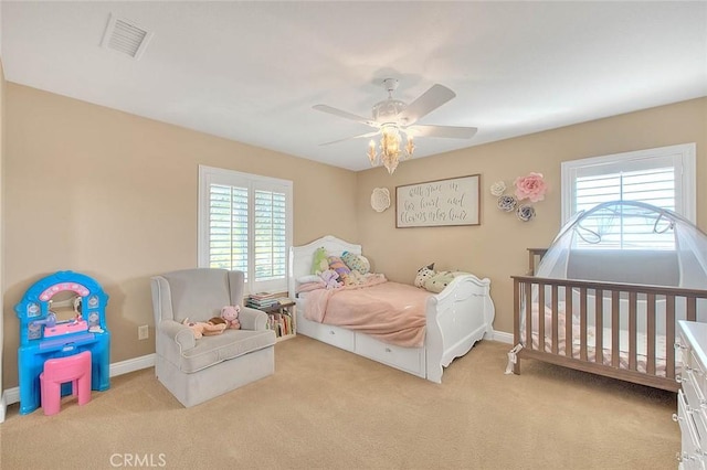 bedroom featuring ceiling fan and light carpet