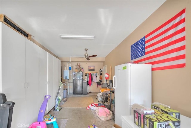 garage with tankless water heater, ceiling fan, and white fridge