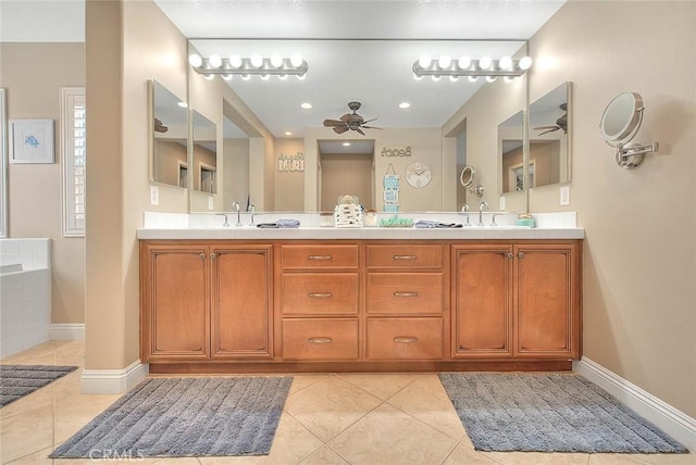 bathroom with ceiling fan, vanity, a bath, and tile patterned flooring