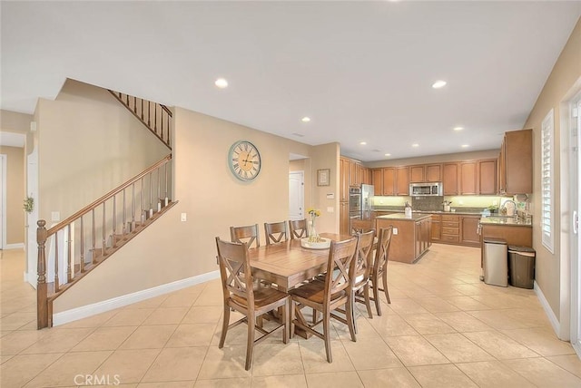 dining space with sink and light tile patterned floors