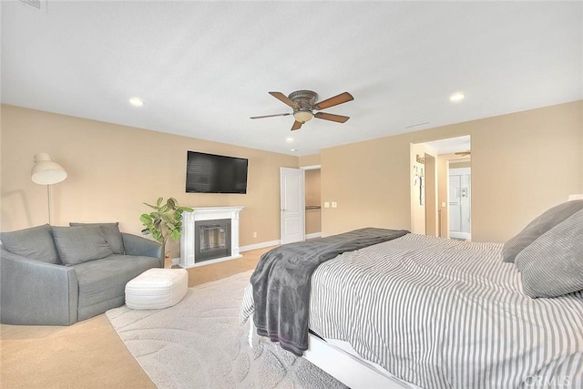 bedroom featuring light colored carpet and ceiling fan