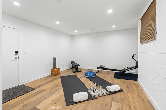 workout area with light hardwood / wood-style flooring