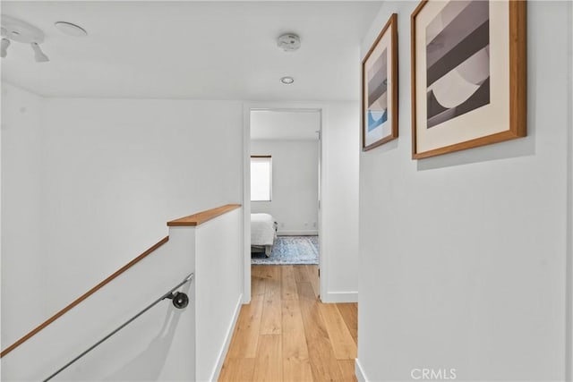 hallway with light hardwood / wood-style floors