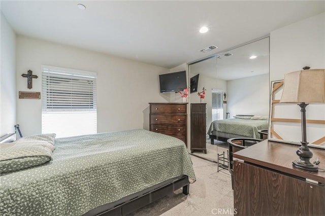 bedroom with light colored carpet