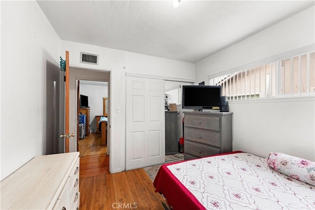 bedroom featuring light hardwood / wood-style floors and a closet