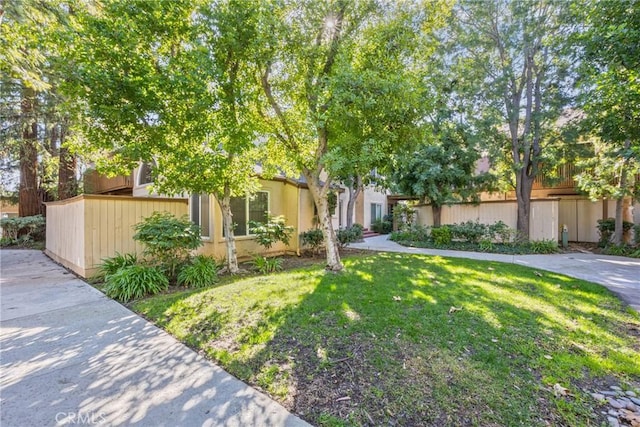 obstructed view of property featuring a front lawn