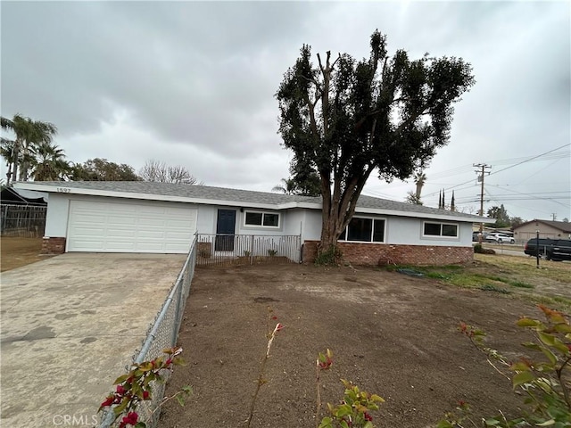 ranch-style home with brick siding, driveway, an attached garage, and stucco siding