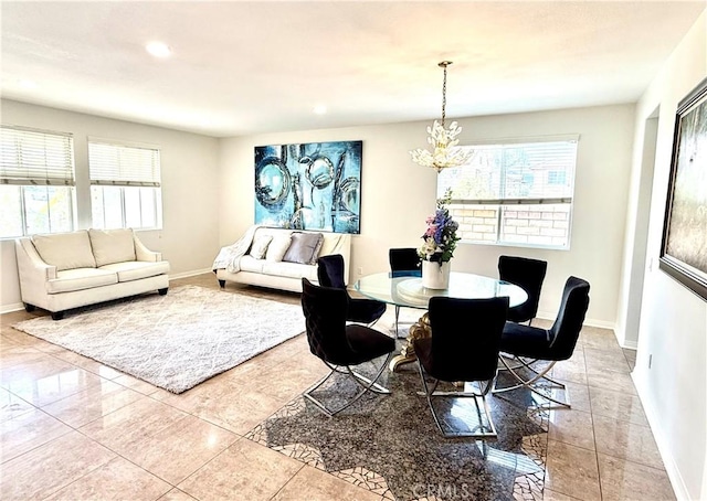 dining space featuring light tile patterned flooring and a chandelier