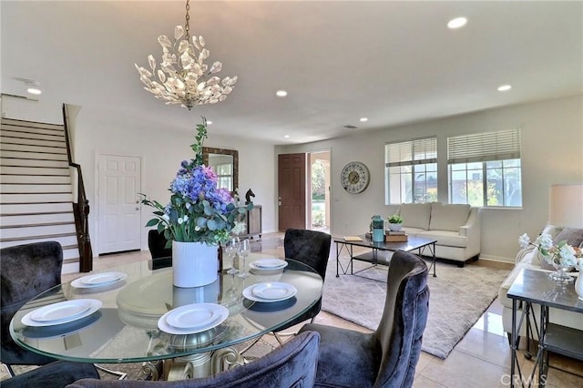 tiled dining space featuring an inviting chandelier