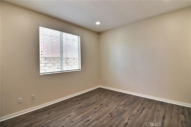 unfurnished room with dark hardwood / wood-style floors