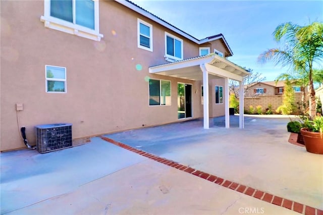 rear view of property featuring cooling unit and a patio area