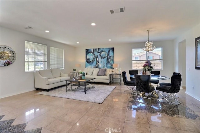 living room featuring a healthy amount of sunlight and a notable chandelier