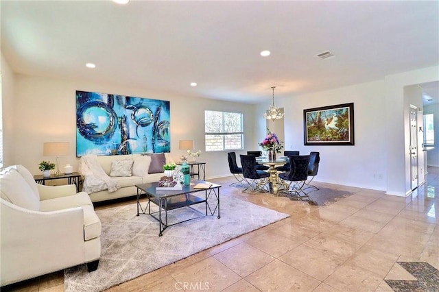 living room with light tile patterned floors and a chandelier