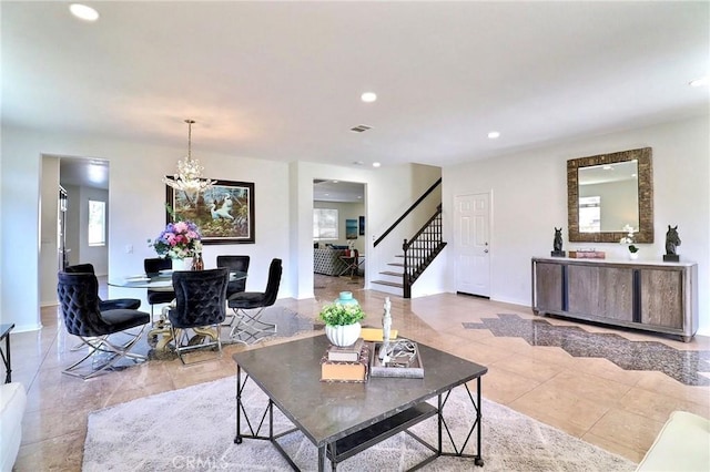 living room featuring an inviting chandelier and light tile patterned floors