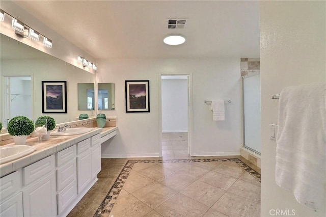 bathroom with an enclosed shower, vanity, and tile patterned floors